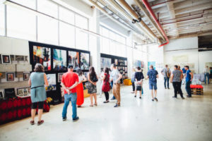 Besucher beschäftigen sich mit Kunst: supermART #9 im Jahr 2019 auf AEG in Nürnberg. Foto von Markus Spiske